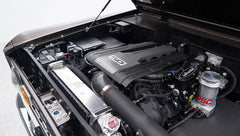 Classic Ford Bronco matte brown engine bay with visible Wilwood brake components and wiring