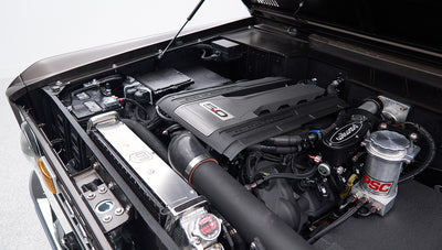 Classic Ford Bronco matte brown engine bay with visible Wilwood brake components and wiring