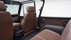 Interior rear view of Classic Ford Bronco with brown leather seats and black roll bar