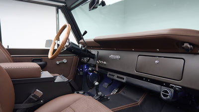 Classic Ford Bronco cabin view from driver side showing dashboard, steering wheel, and seats