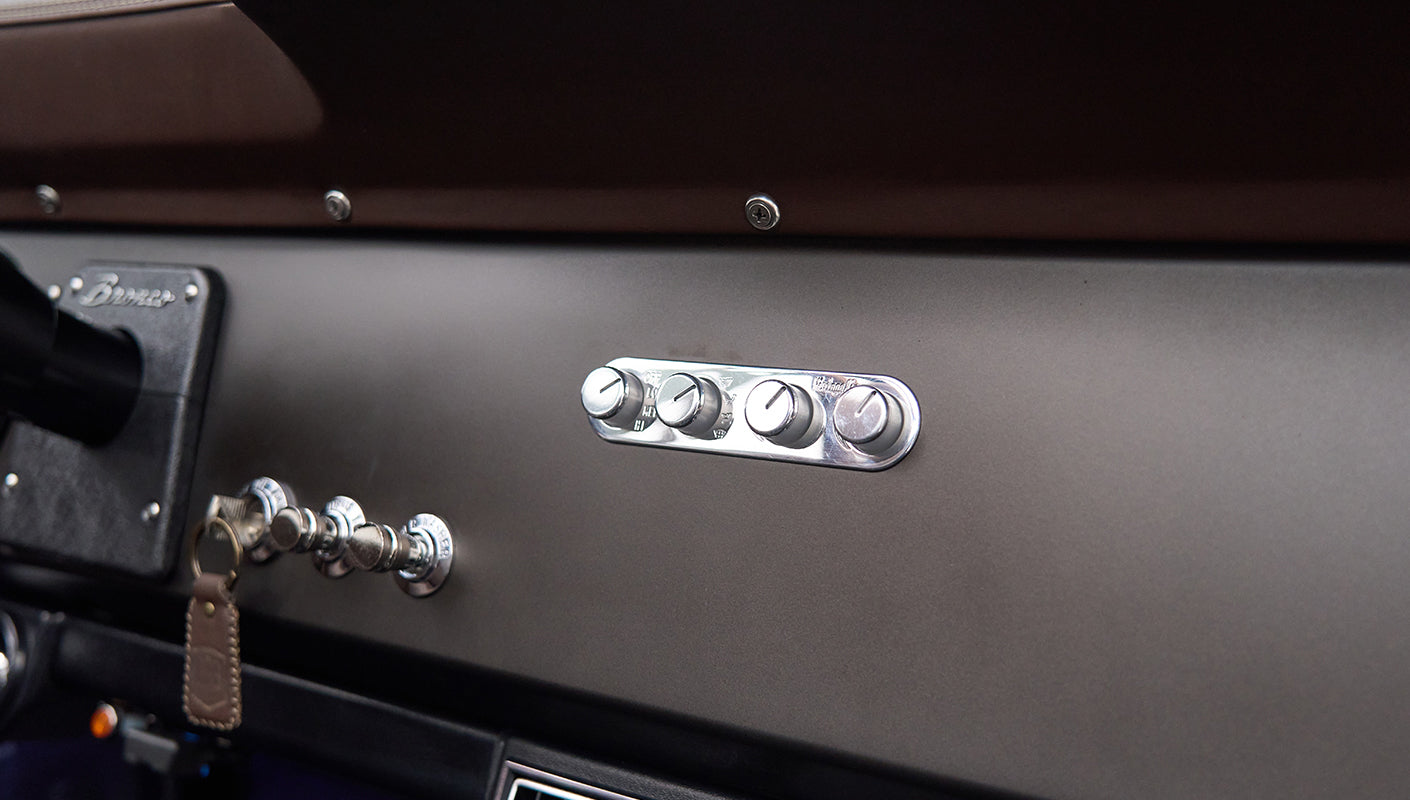Close-up of four chrome dashboard knobs in Classic Ford Bronco interior