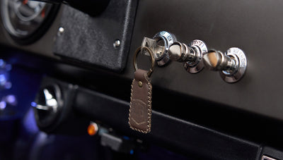 Close-up of a Classic Ford Bronco dashboard with key and leather keychain inserted