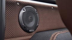 Close-up of speaker embedded in the brown textured panel inside Classic Ford Bronco