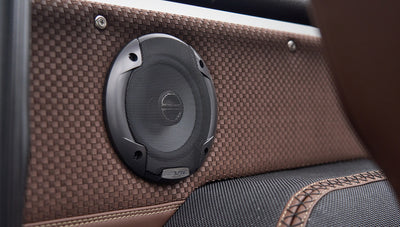 Close-up of speaker embedded in the brown textured panel inside Classic Ford Bronco