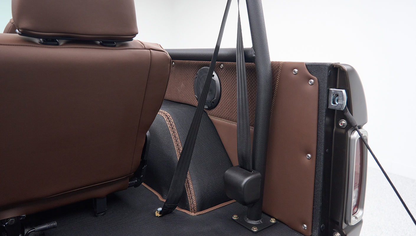 Brown leather interior and seat belt detail inside Classic Ford Bronco near wheel well