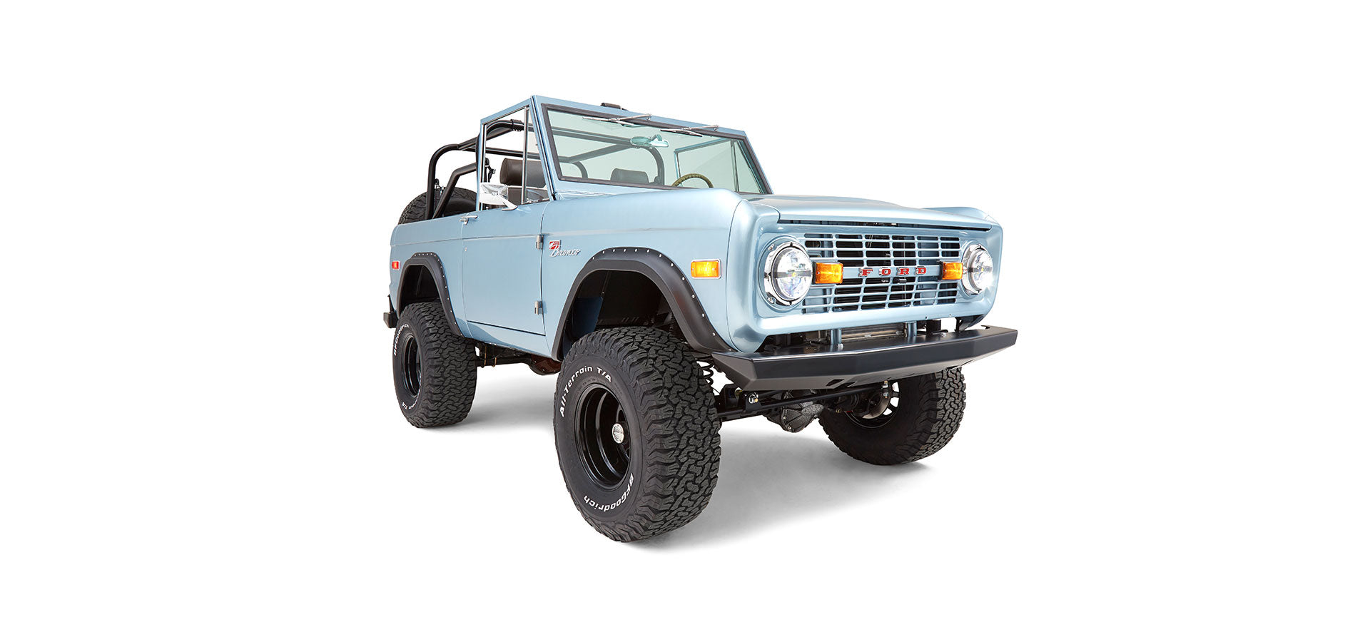 Light metallic blue Classic Ford Bronco angled front view with lifted wheel stands