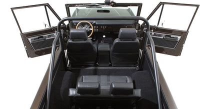 Rear interior view of Classic Ford Bronco with black seats and open doors