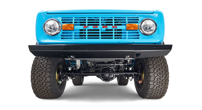 Front underside view of a bright blue Classic Ford Bronco with visible suspension and tires