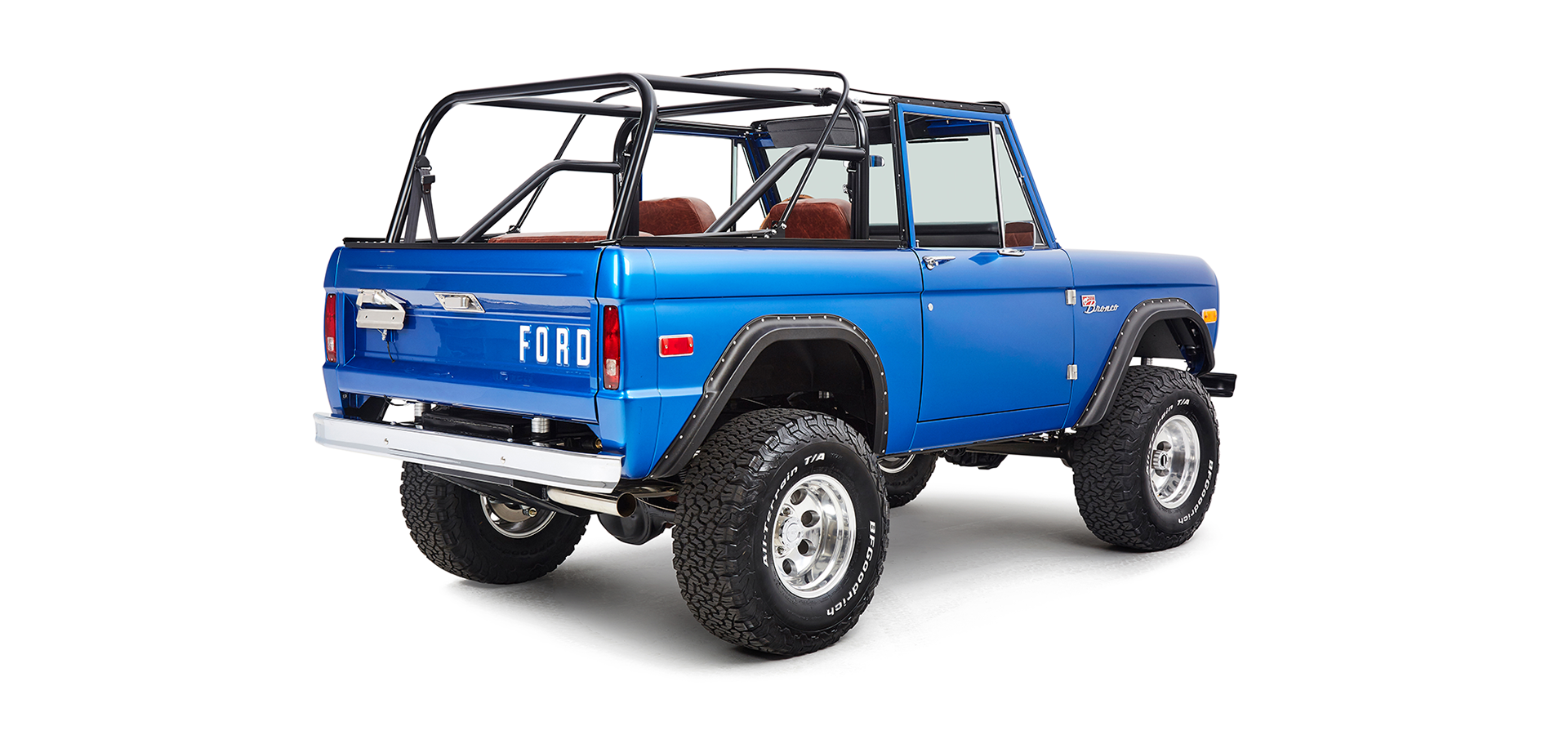 Classic Ford Bronco rear passenger angled view showing tailgate and large off-road tires