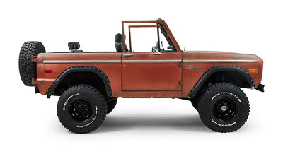 Classic Ford Bronco side profile with door and large off-road tires