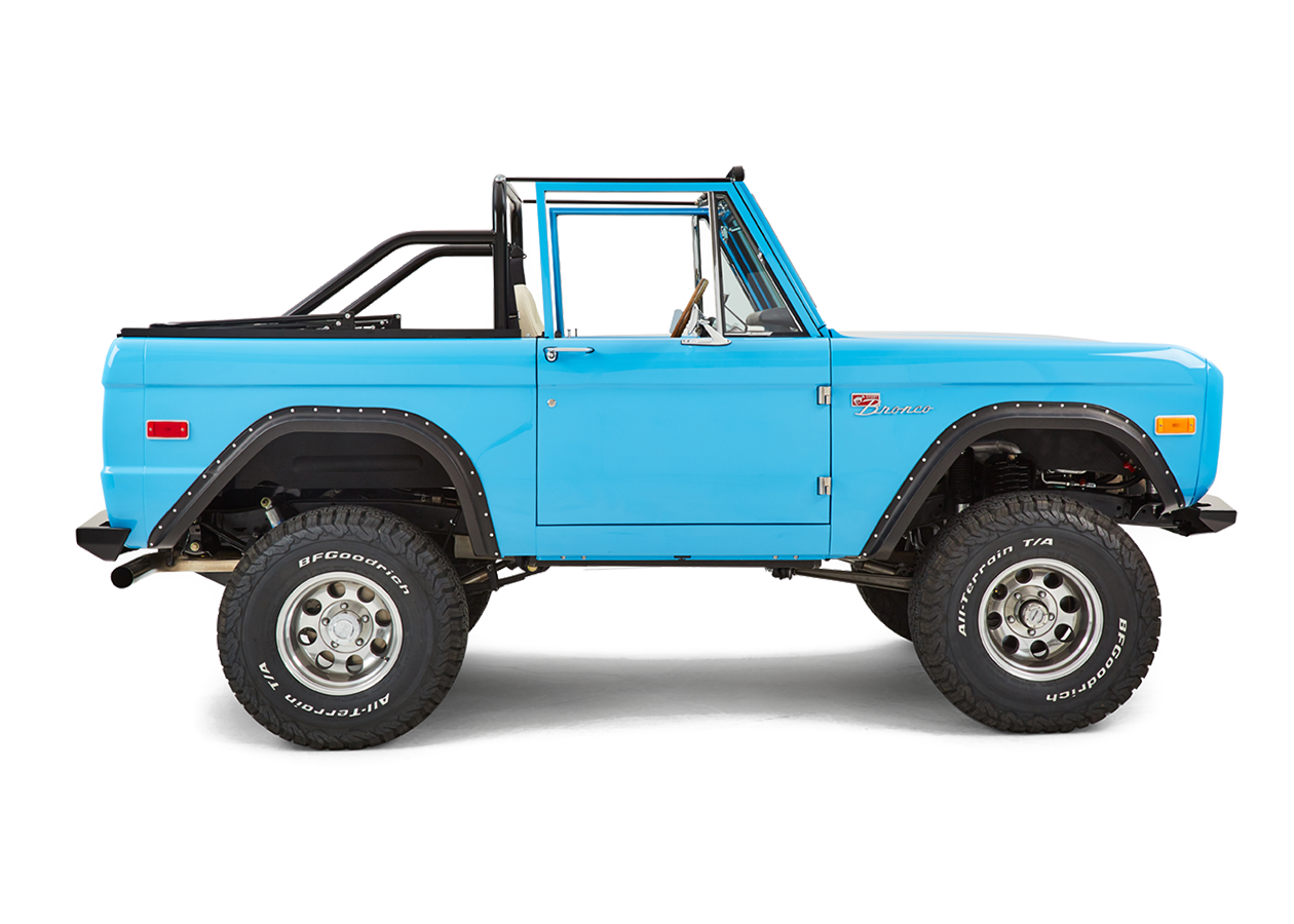 Side profile of blue Classic Ford Bronco passenger side with black fender flares and off-road tires.