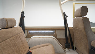 Rear interior seats of Classic Ford Bronco with tan upholstery and black seat belts