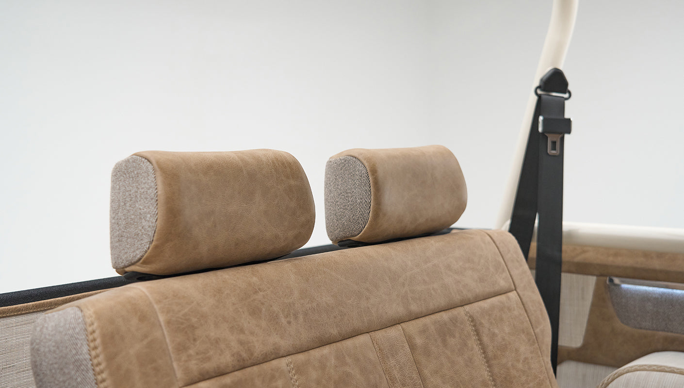 Close-up detail of tan upholstery and headrests in Classic Ford Bronco rear seats