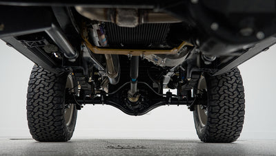 View of the rear underside suspension components and tires of Classic Ford Bronco