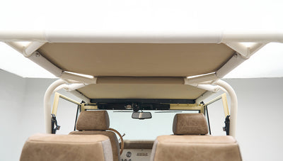 Rear view of beige leather and fabric seat headrests inside Classic Ford Bronco