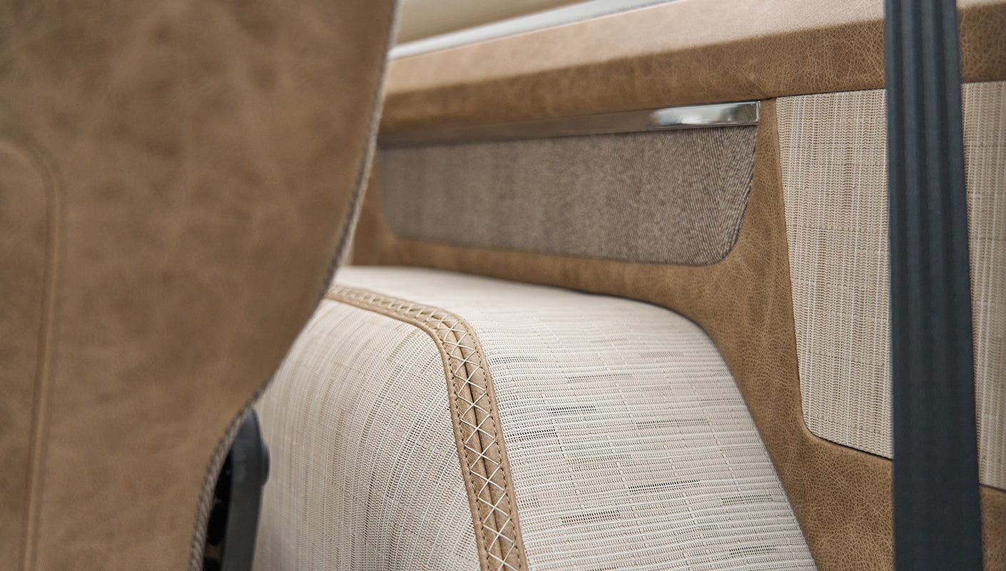 Detailed upholstery stitching and fabric pattern on beige leather interior of Classic Ford Bronco