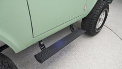 Classic Ford Bronco side view focusing on black running board and rear tire