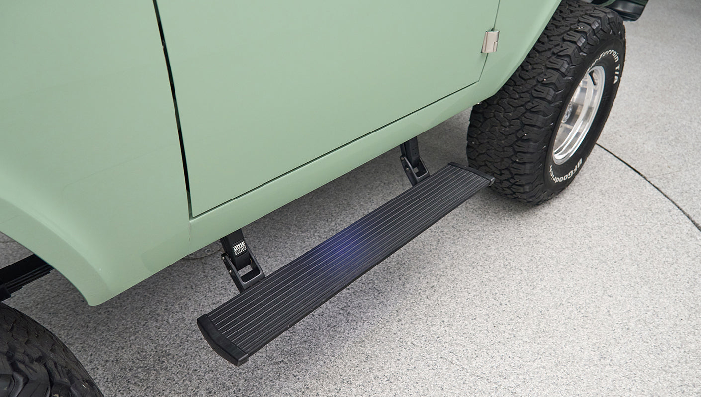 Classic Ford Bronco side view focusing on black running board and rear tire