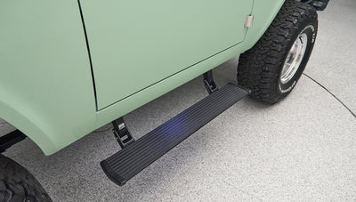 Classic Ford Bronco side view focusing on black running board and rear tire