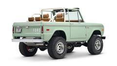 Classic Ford Bronco with porcelain green paint and tan interior, shown from rear side angle