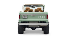 Rear view of porcelain green Classic Ford Bronco with raised suspension and FORD lettering on tailgate