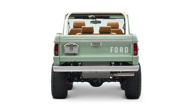 Rear view of porcelain green Classic Ford Bronco with raised suspension and FORD lettering on tailgate