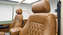 Close-up of brown leather front seats with diamond stitching in Classic Ford Bronco