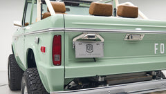 Rear exterior side of Classic Ford Bronco with green paint, tail light and license plate