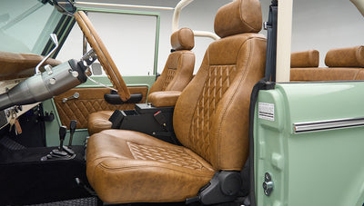 Interior view of tan leather seats and steering wheel inside a Classic Ford Bronco