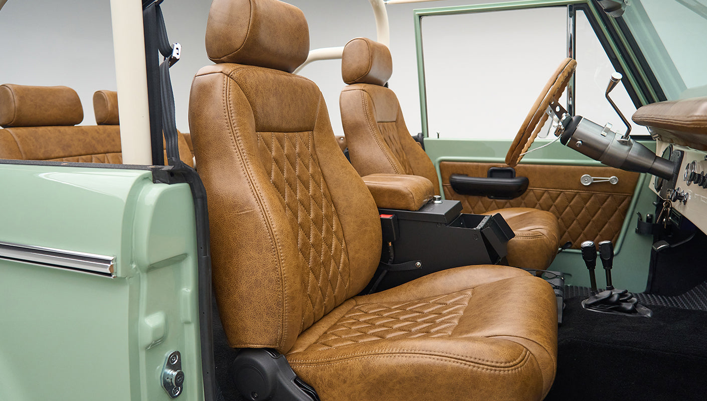 Front seats in tan leather upholstery with diamond stitching inside Classic Ford Bronco