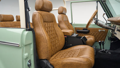 Front seats in tan leather upholstery with diamond stitching inside Classic Ford Bronco