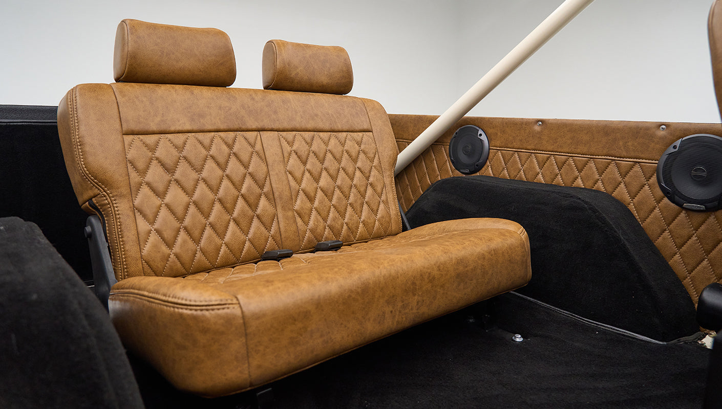 Another angle of the rear bench seat in Classic Ford Bronco highlighting the brown leather detail