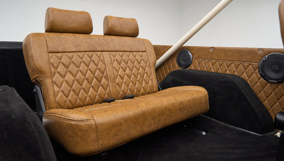 Another angle of the rear bench seat in Classic Ford Bronco highlighting the brown leather detail