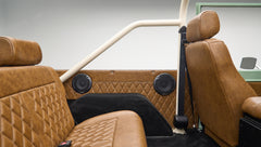 Interior view of rear seating area in Classic Ford Bronco with brown diamond-stitched leather seats