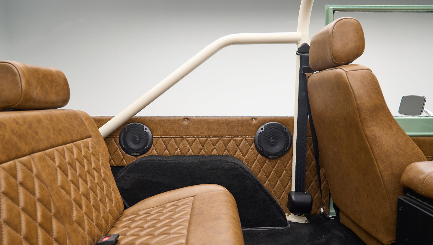 Interior view of rear seating area in Classic Ford Bronco with brown diamond-stitched leather seats