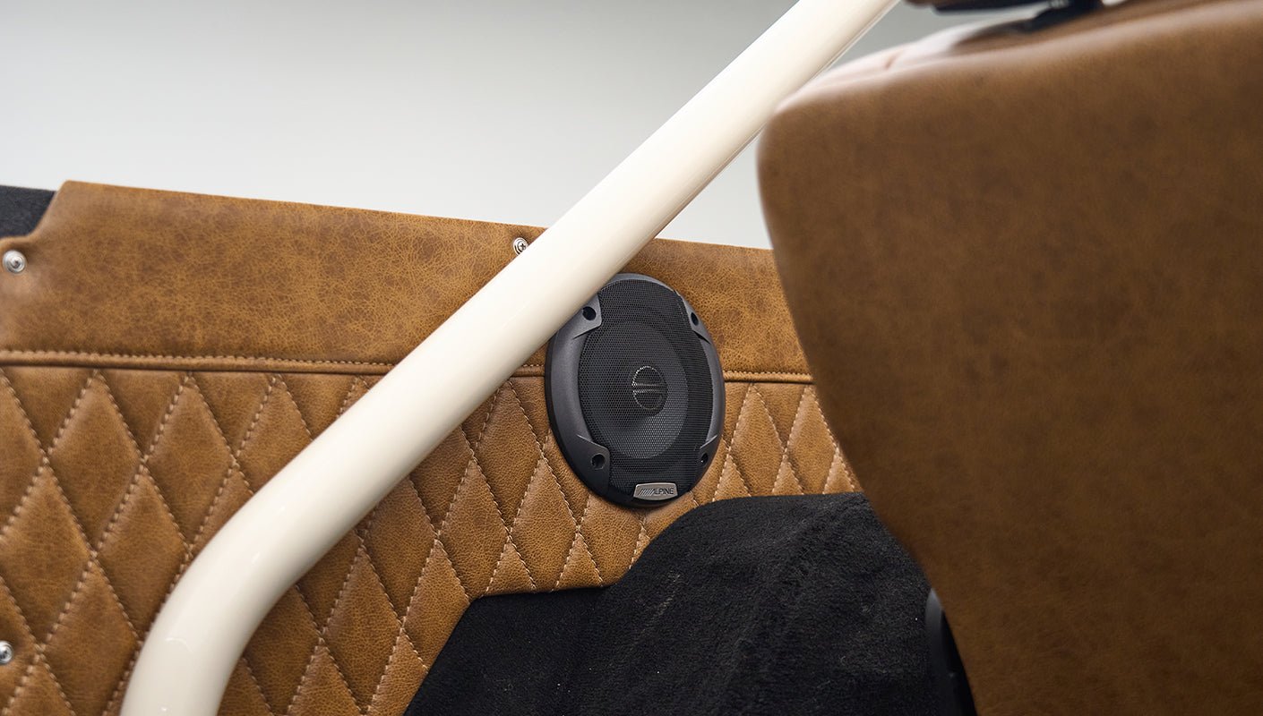 Speaker embedded in brown diamond-stitched panel inside rear of Classic Ford Bronco