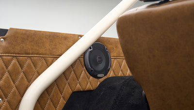 Speaker embedded in brown diamond-stitched panel inside rear of Classic Ford Bronco