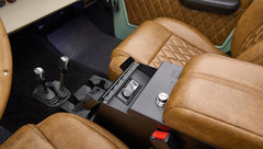Interior center console and two gear shifters with brown leather seats in Classic Ford Bronco