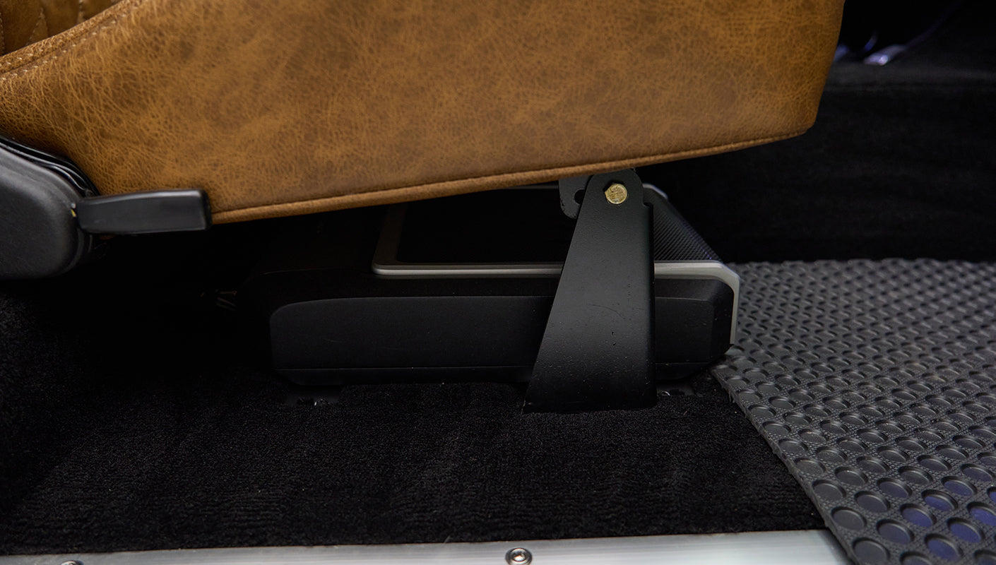 Under-seat storage mounted under brown leather seat in Classic Ford Bronco