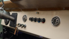 Gray dashboard with switches and air vents in Classic Ford Bronco