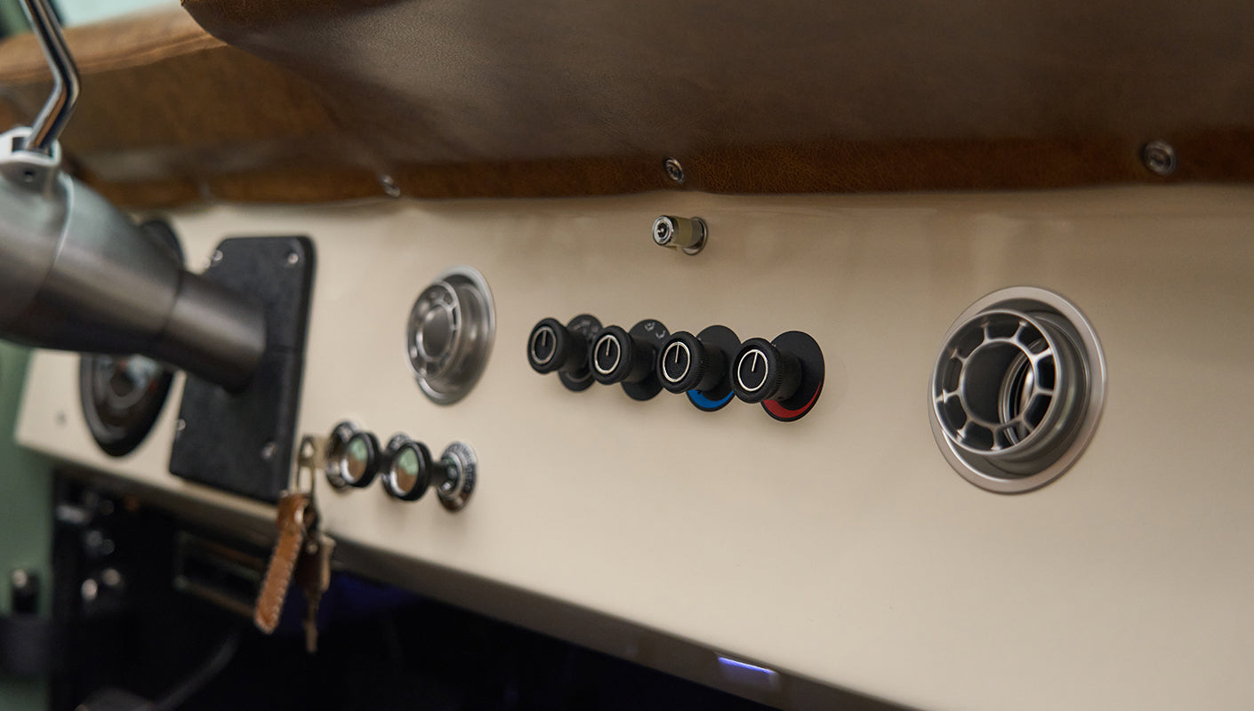 Gray dashboard with switches and air vents in Classic Ford Bronco