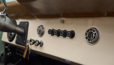 Gray dashboard with switches and air vents in Classic Ford Bronco
