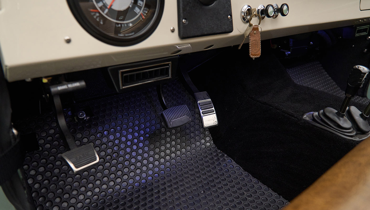 Black and white round speedometer and dashboard switches with ignition key in Classic Ford Bronco