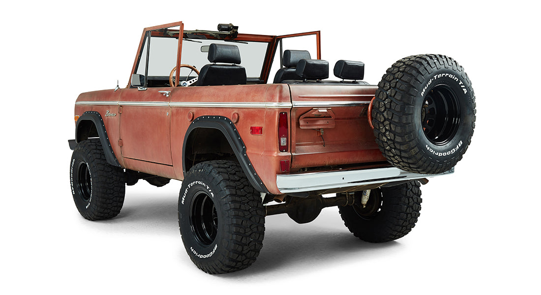 Classic Ford Bronco rear driver side angled view showing spare tire and open top