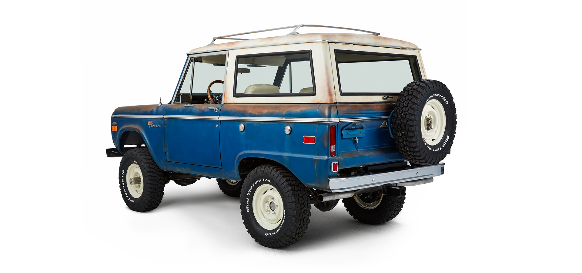 Classic Ford Bronco rear driver side angled view featuring body and spare tire