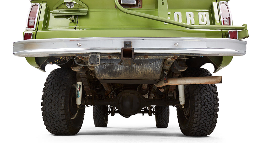 Undercarriage rear view of green Classic Ford Bronco showing rear axle and suspension
