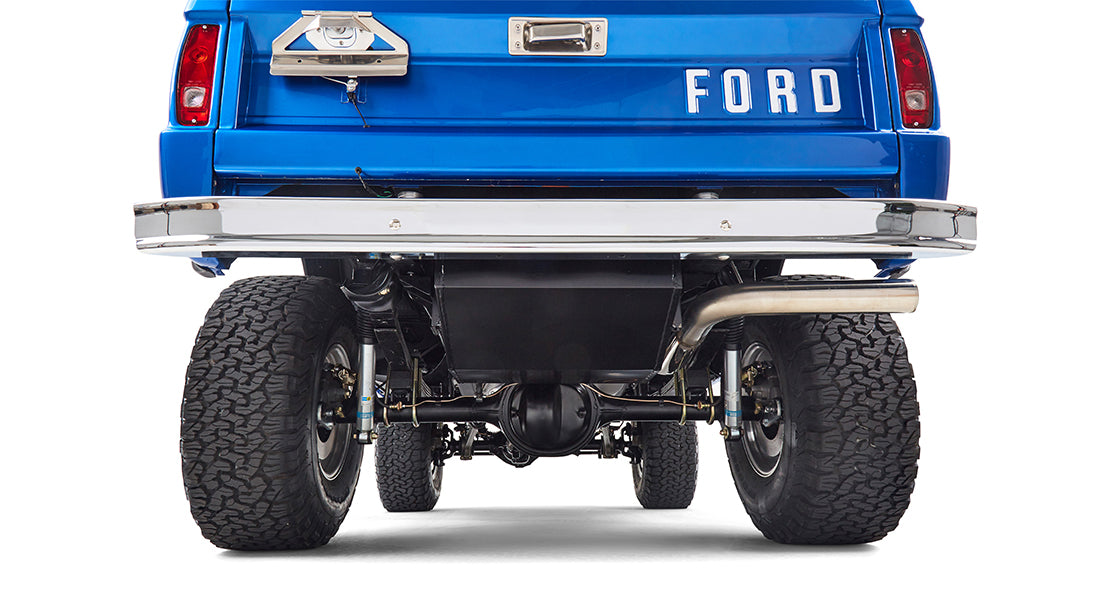 Underbody view of Classic Ford Bronco showing rear differential, suspension, exhaust, and large tires