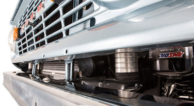 Close-up of light blue Classic Ford Bronco lower front grille and suspension components