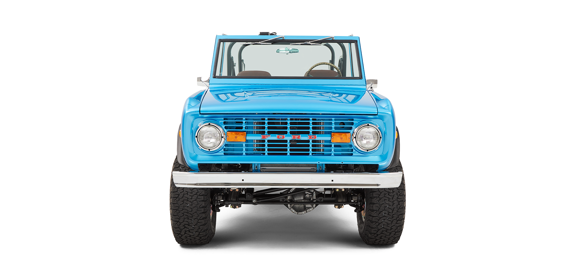 Front view of sky blue Classic Ford Bronco showing grille, headlights, and raised tires