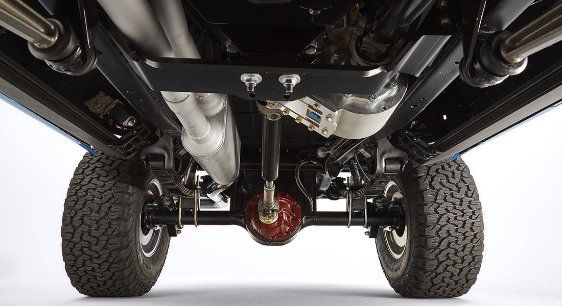 Underbody view showing rear axle, differential, and suspension components.